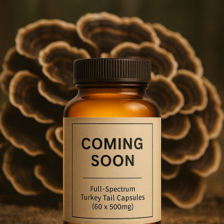 “Amber glass bottle labeled ‘Coming Soon’ with Full-Spectrum Turkey Tail Capsules surrounded by capsules and Turkey Tail mushrooms in the background.”